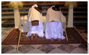 Masked men kneeling in front of the altar 