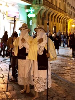 Hooded pilgrims performing a Christian ritual 