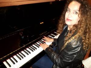 My friend hitting a few notes on the grand piano at Giudamino